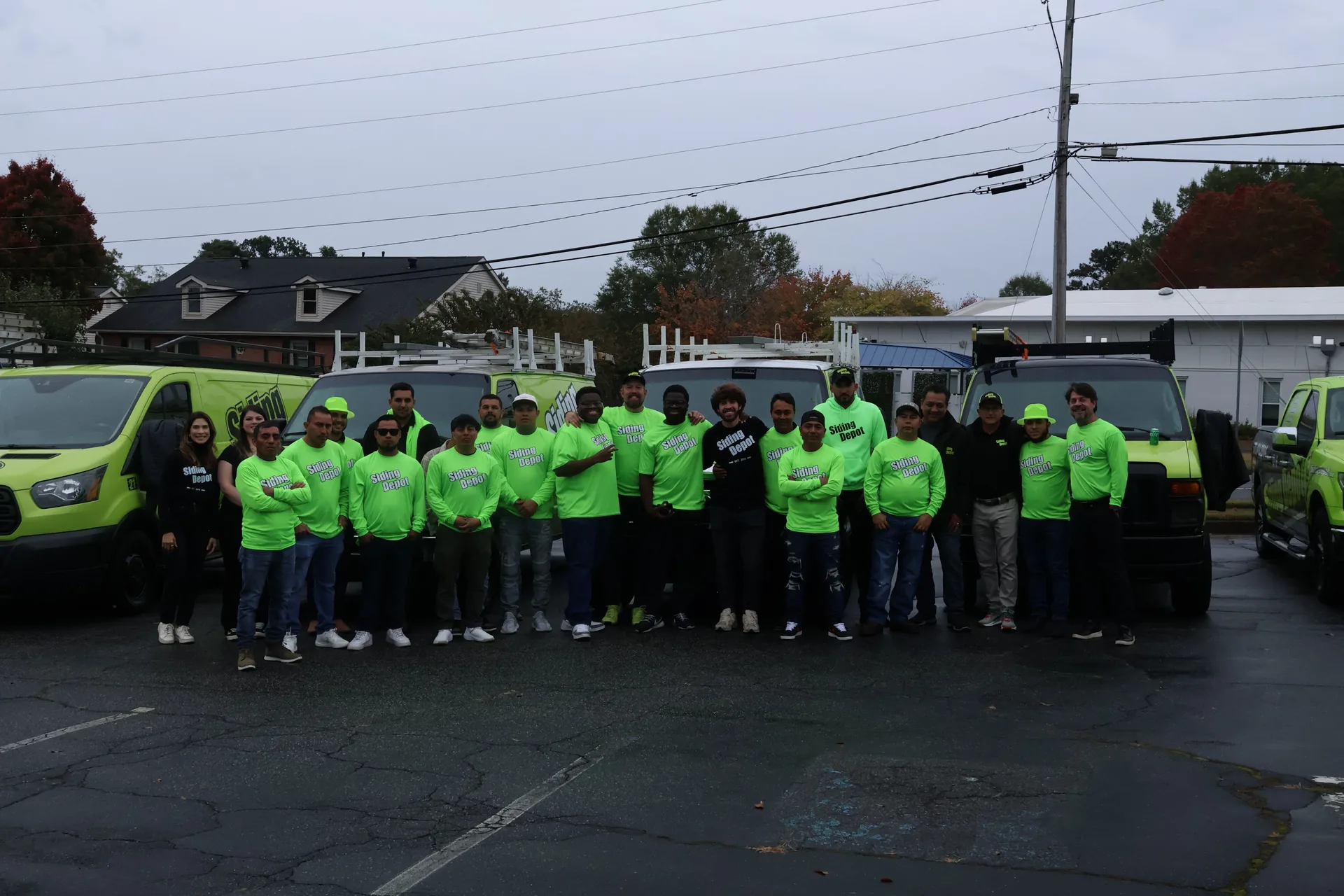 The Siding Depot crew — our full in-house team in front of the company vans