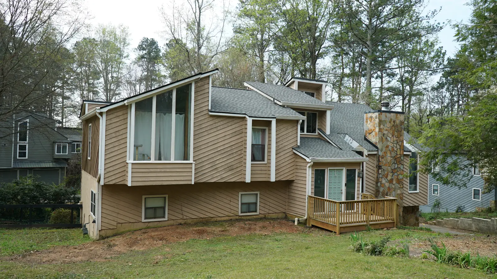 Marietta home before renovation with faded tan siding and worn trim